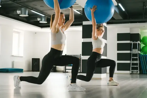 Women doing lunges with fitballs in gym 2024 07 10 03 35 32 utc